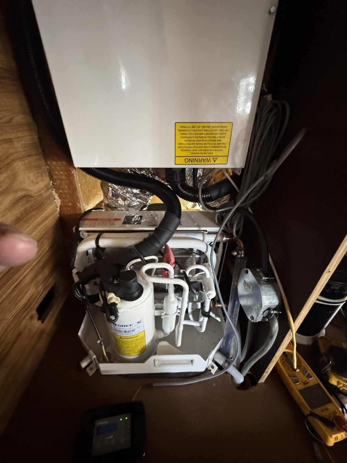 Marine air conditioning unit mounted under a berth on a boat